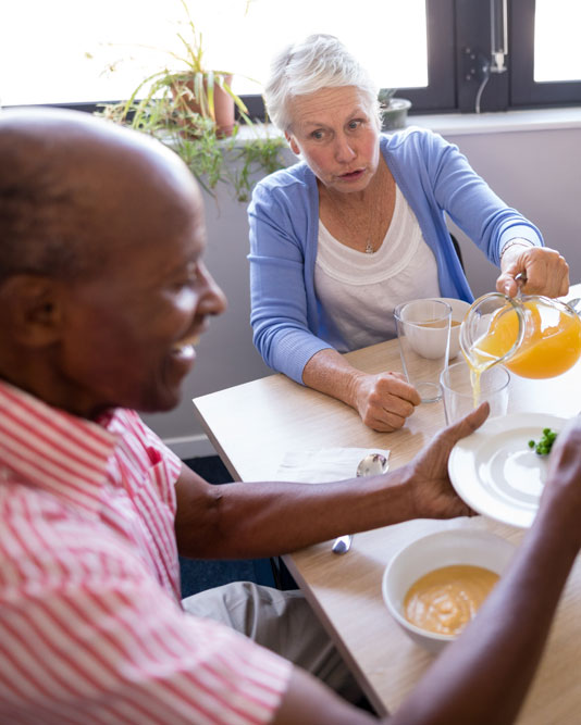 Seniors eating and drinking a healthy meal